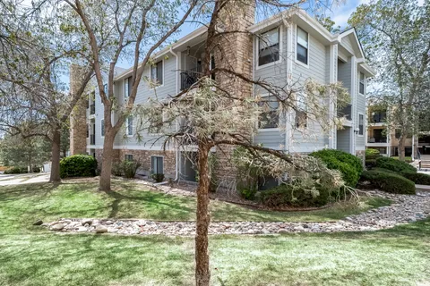 a view of a house with yard and sitting area