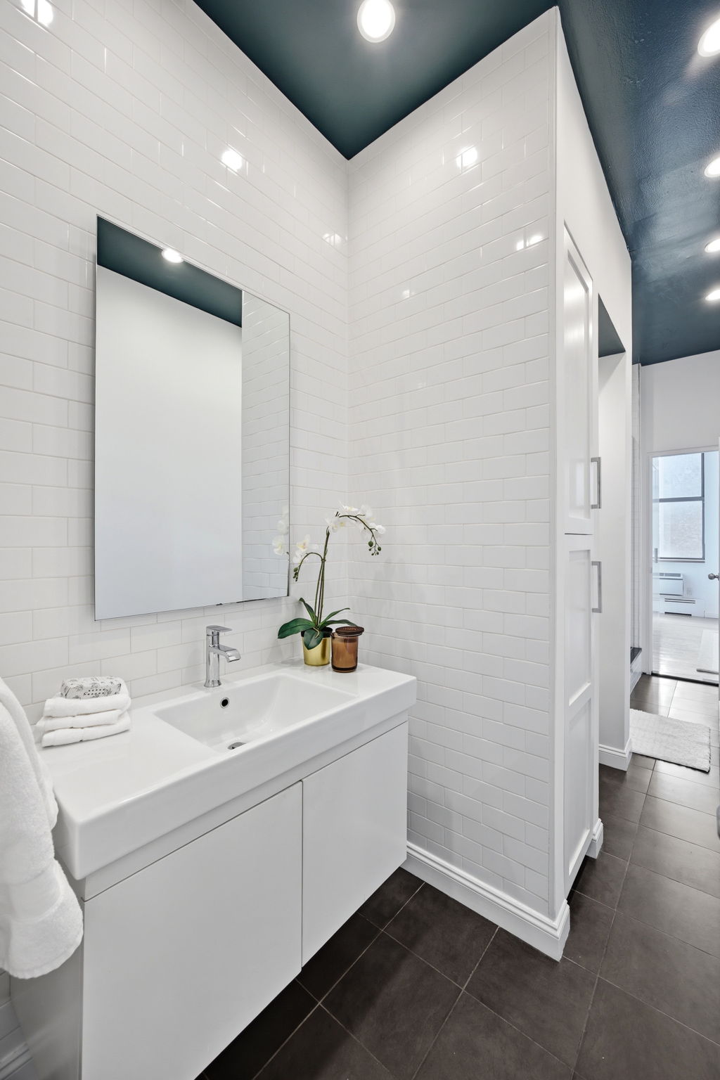 114 East 13th Street, Unit 6B Manhattan, NY 10003 - Photo 9 of 12 a bathroom with a sink and a mirror
