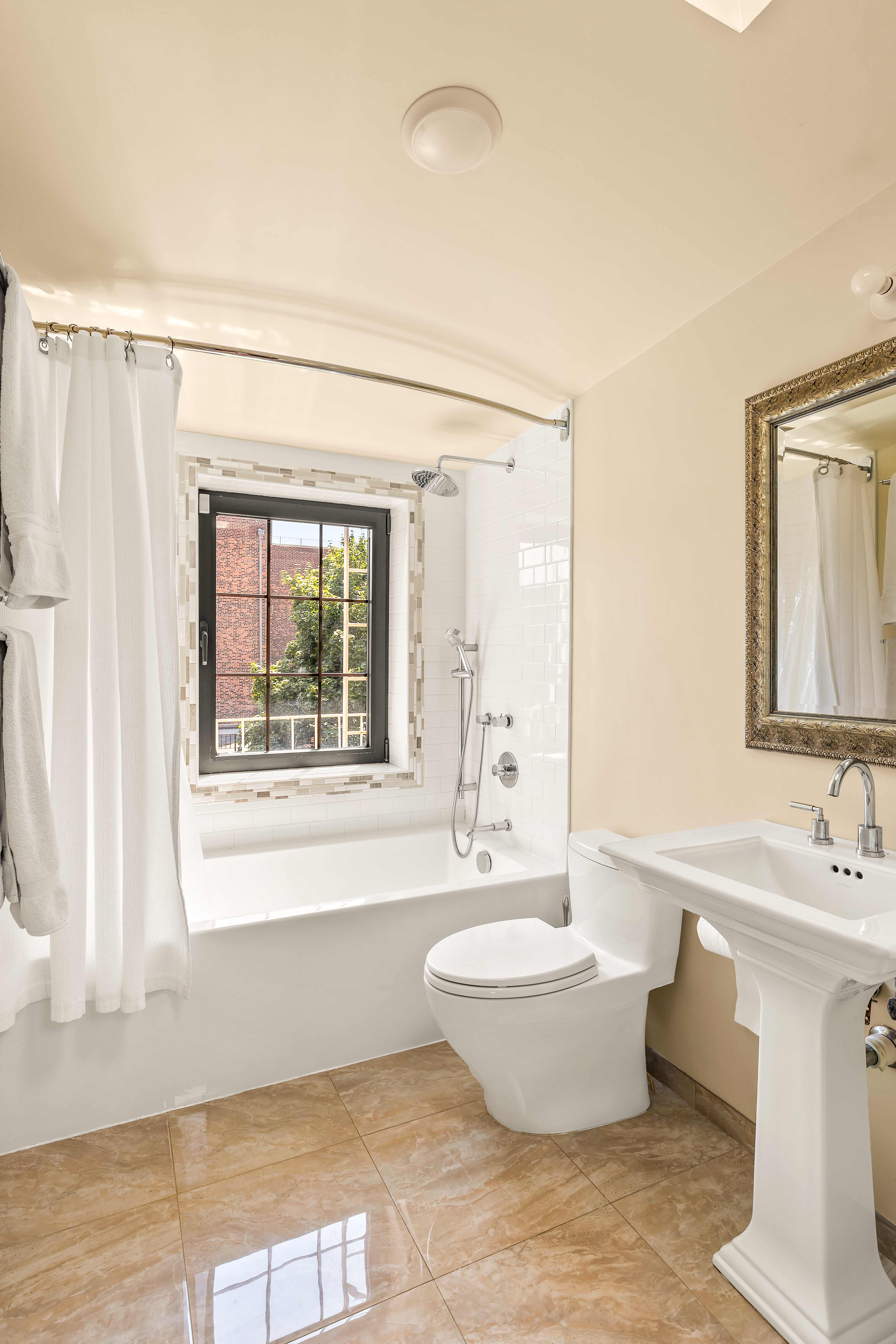 124 Carroll Street, Unit 2 Brooklyn, NY 11231 - Photo 8 of 13 a bathroom with a bathtub sink and mirror