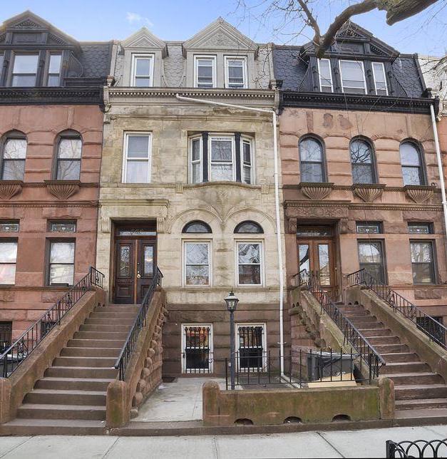 560 Macon Street, Unit 1 Brooklyn, NY 11233 - Photo 5 of 6 a front view of a residential apartment building with a yard