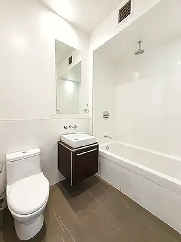 128 Newton Street, Unit 2B Brooklyn, NY 11222 - Photo 4 of 13 a bathroom with a bathtub sink mirror and toilet