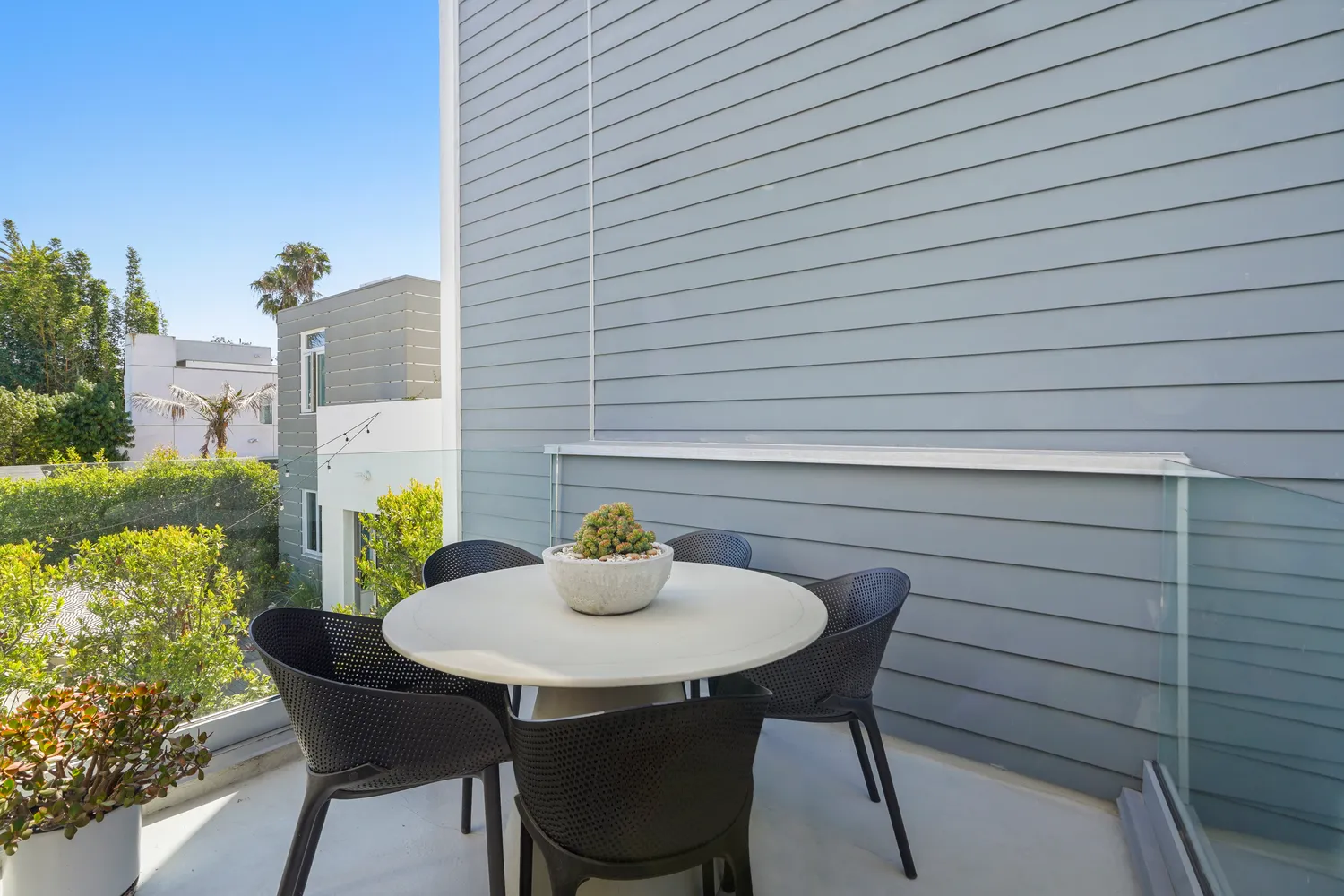 a table and chairs in patio of a house