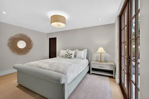 a bedroom with bed and a chandelier