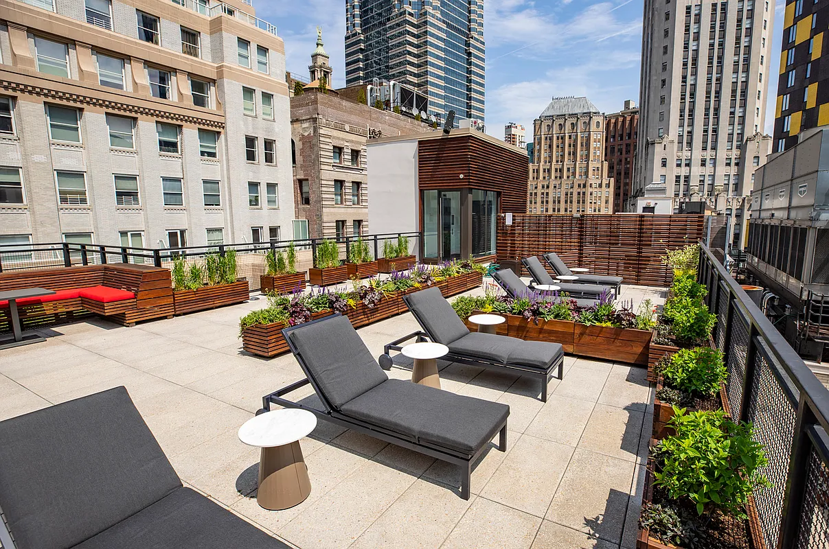 25 Broad Street, Unit 16I Manhattan, NY 10004 - Photo 19 of 23 a view of a patio with couches and potted plants