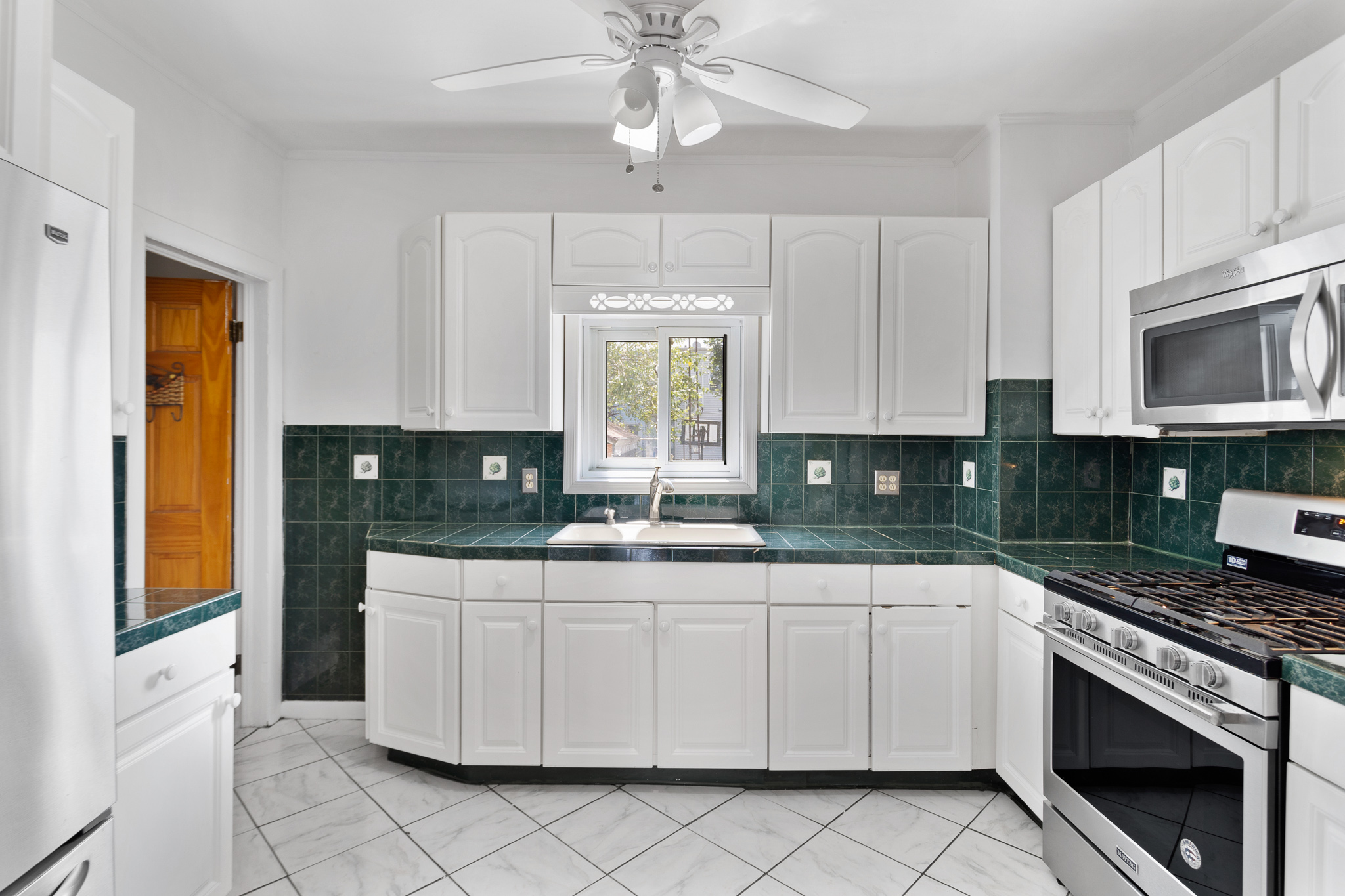 91-22 92nd Street Queens, NY 11421 - Photo 6 of 27 a kitchen with stainless steel appliances granite countertop a sink and cabinets