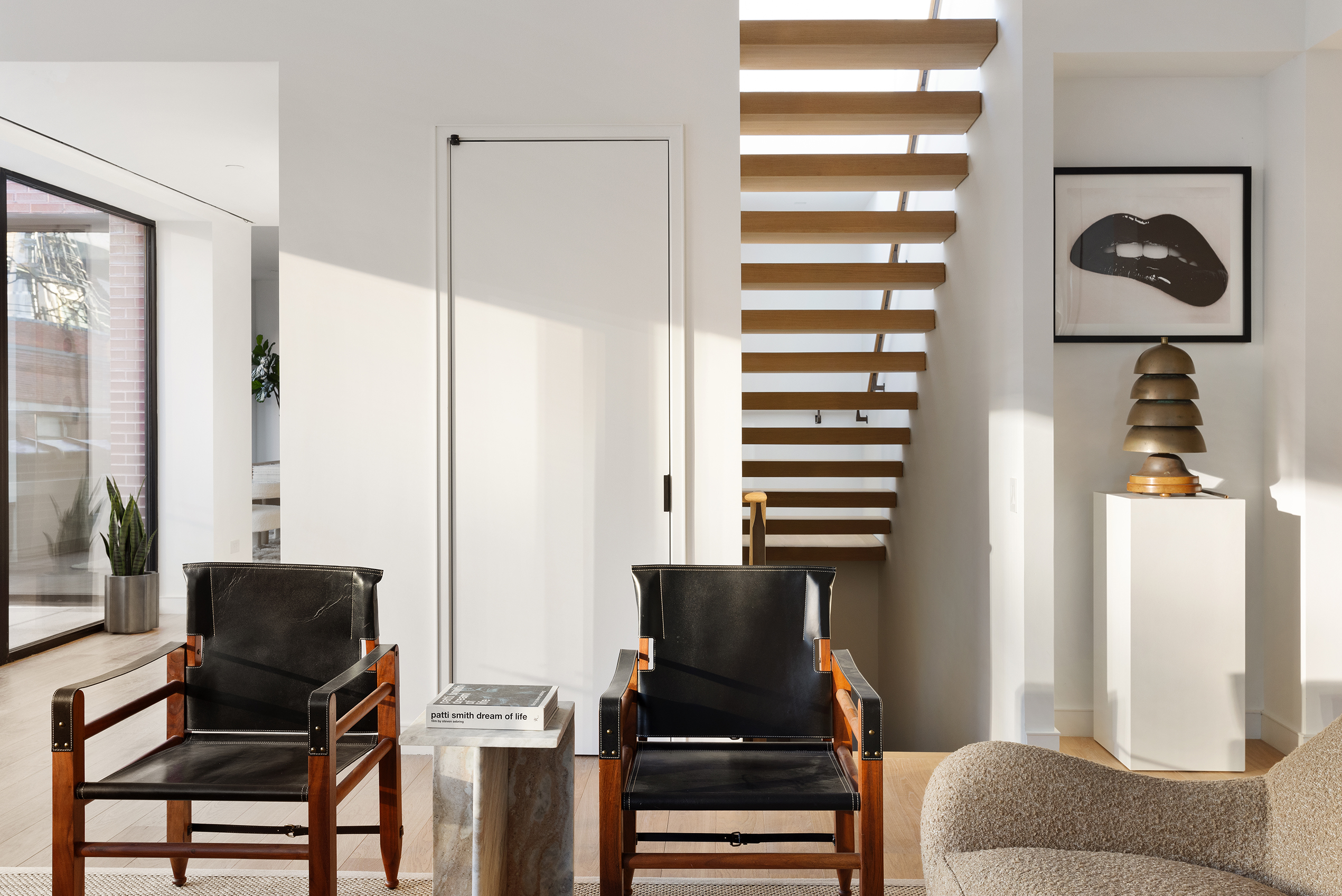 500 West 22nd Street, Unit 8W Manhattan, NY 10011 - Photo 15 of 27 a living room with furniture and a lamp