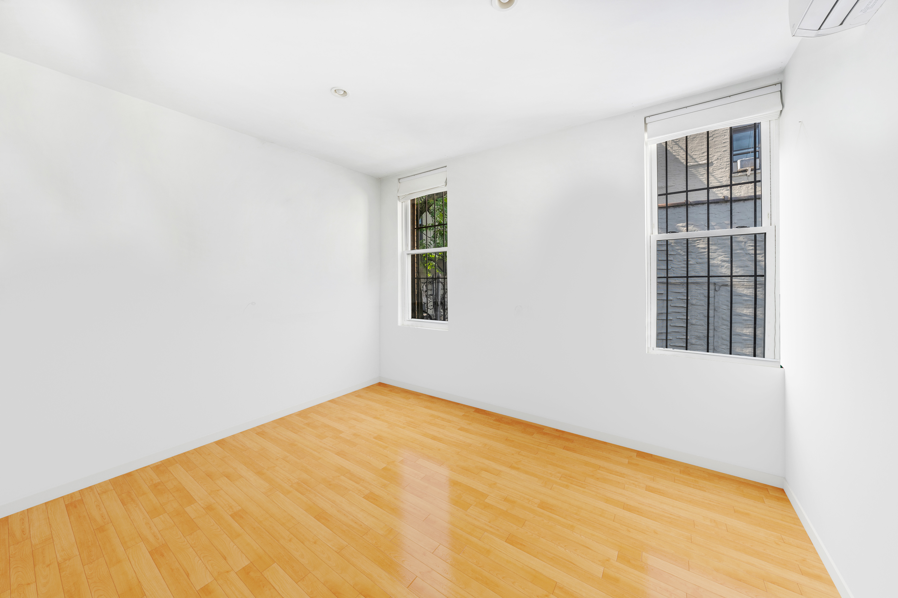 354 Grand Street Brooklyn, NY 11211 - Photo 9 of 14 a view of an empty room with windows