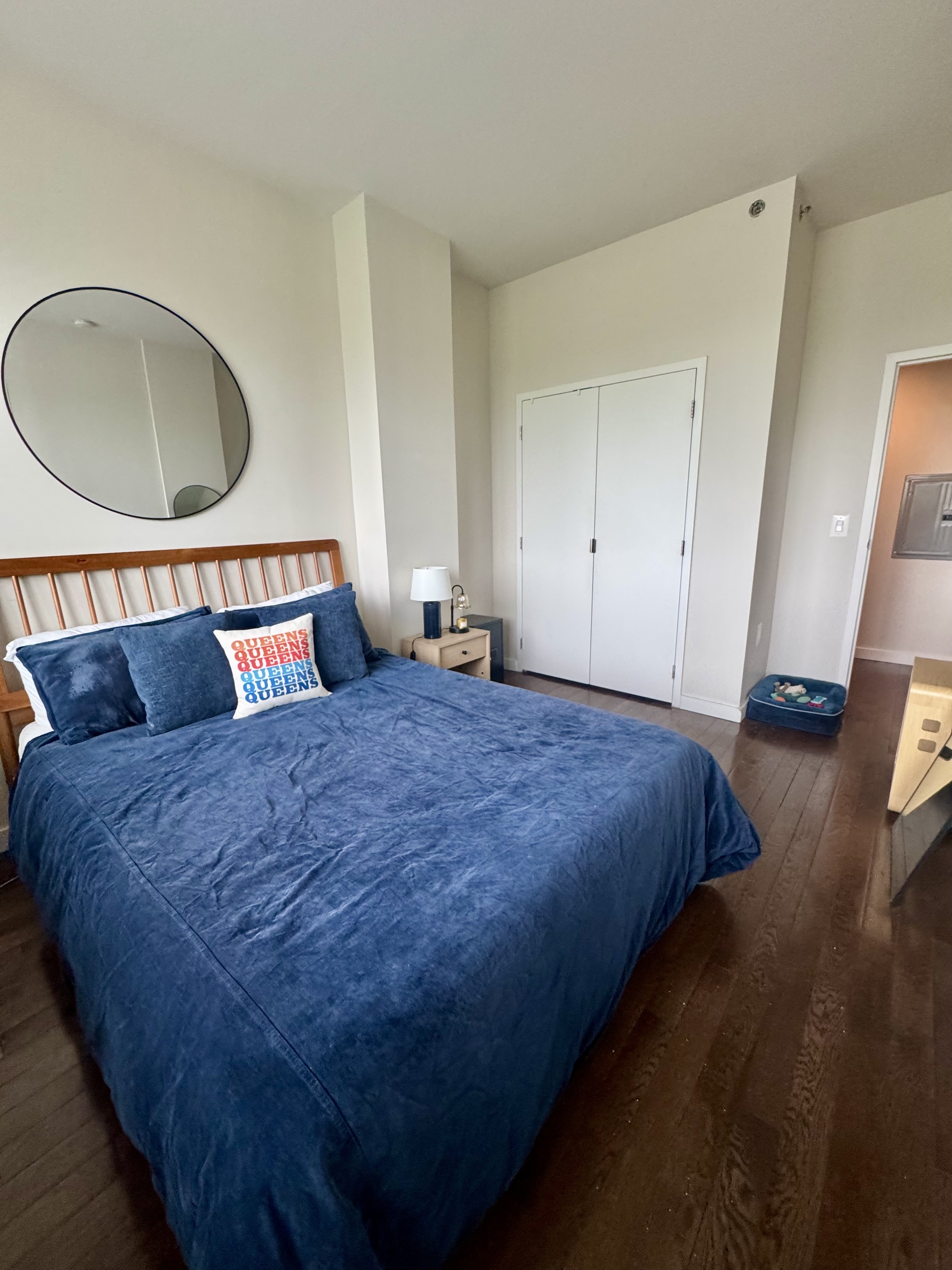 Broadway, Unit 306 Queens, NY 11106 - Photo 5 of 7 a bedroom with a bed and a dresser next to it
