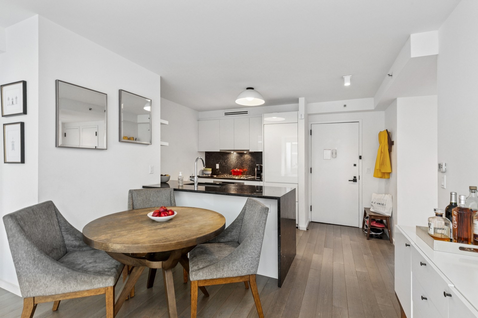 385 1st Avenue, Unit 6B Manhattan, NY 10010 - Photo 4 of 15 a kitchen with a dining table chairs and white kitchen