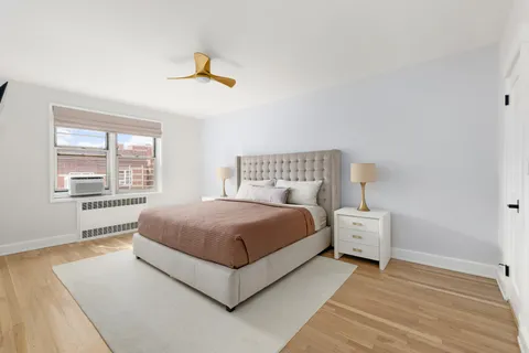 a spacious bedroom with a bed and large windows