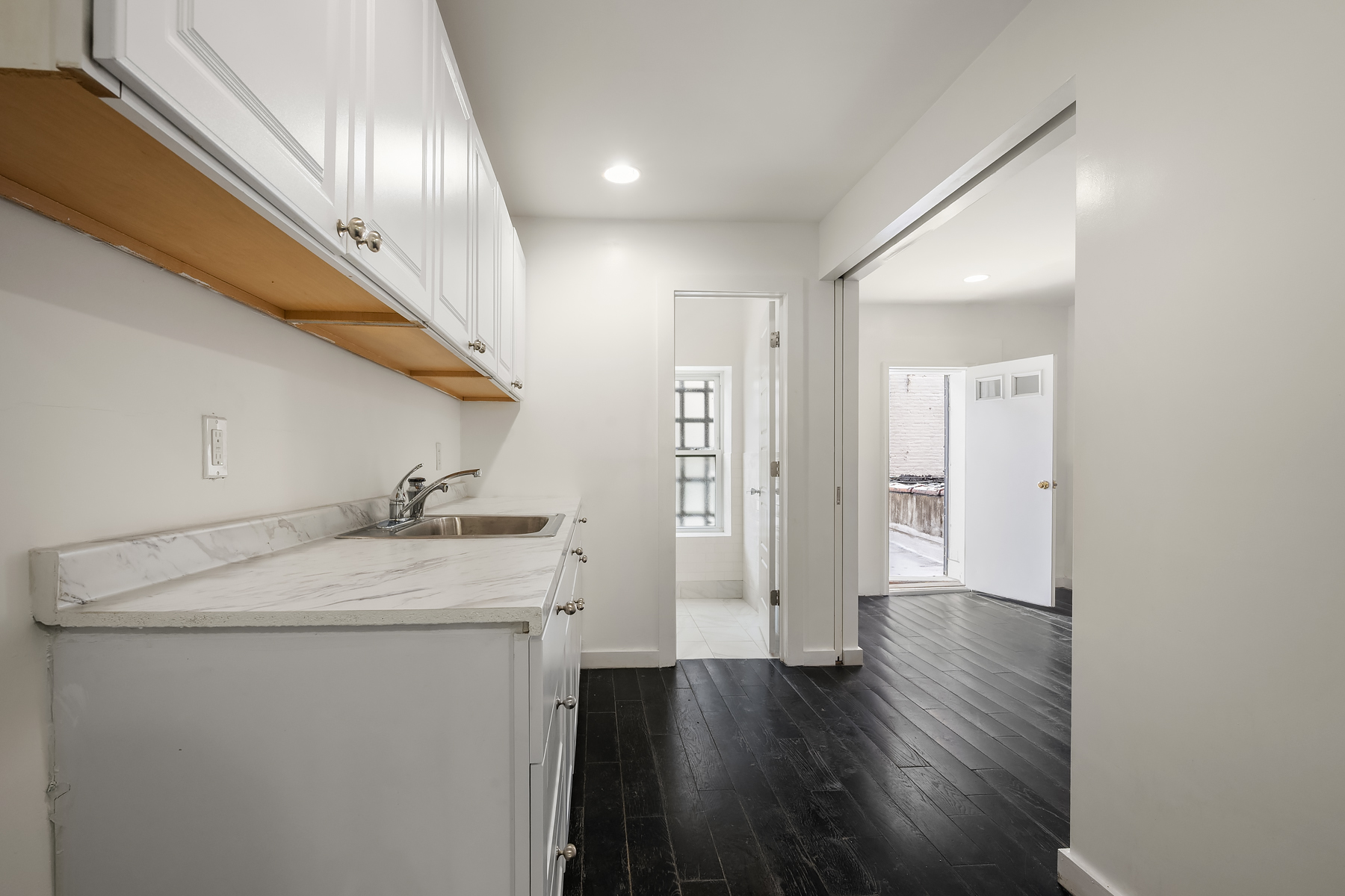 273 Lenox Avenue Manhattan, NY 10027 - Photo 13 of 15 a view of a storage & utility room with wooden floor