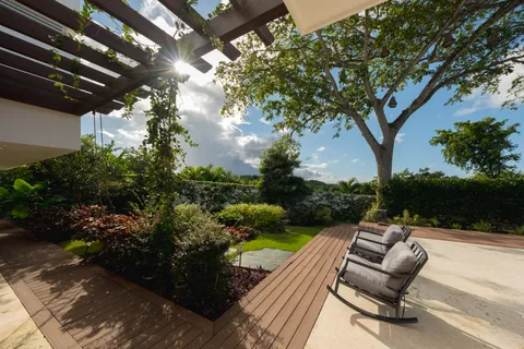 a bedroom with a bed lamp and a large window