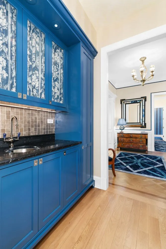 a bedroom with a bed and wooden cabinets