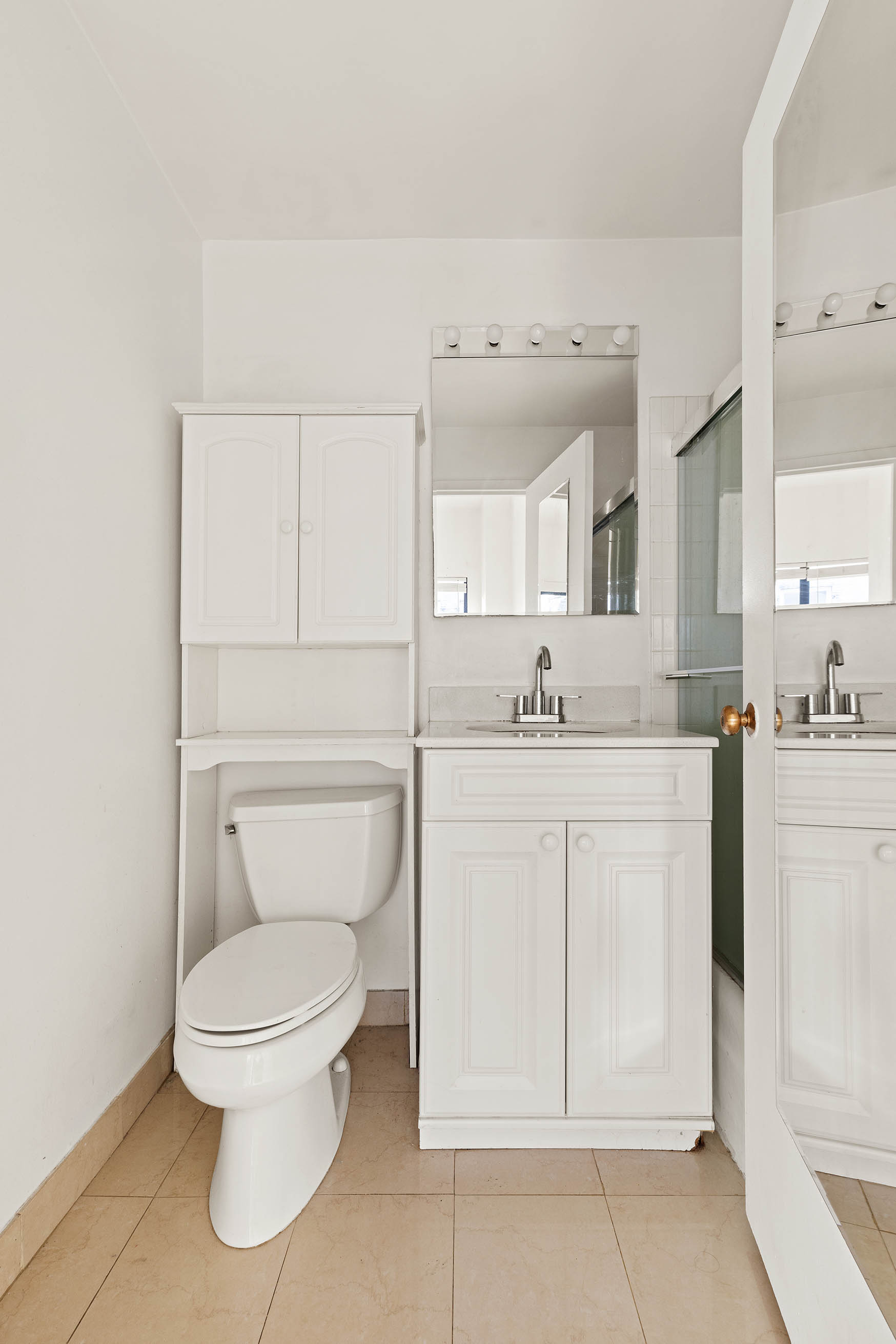35 East 10th Street, Unit 3E Manhattan, NY 10003 - Photo 5 of 8 a spacious bathroom with a toilet sink and mirror