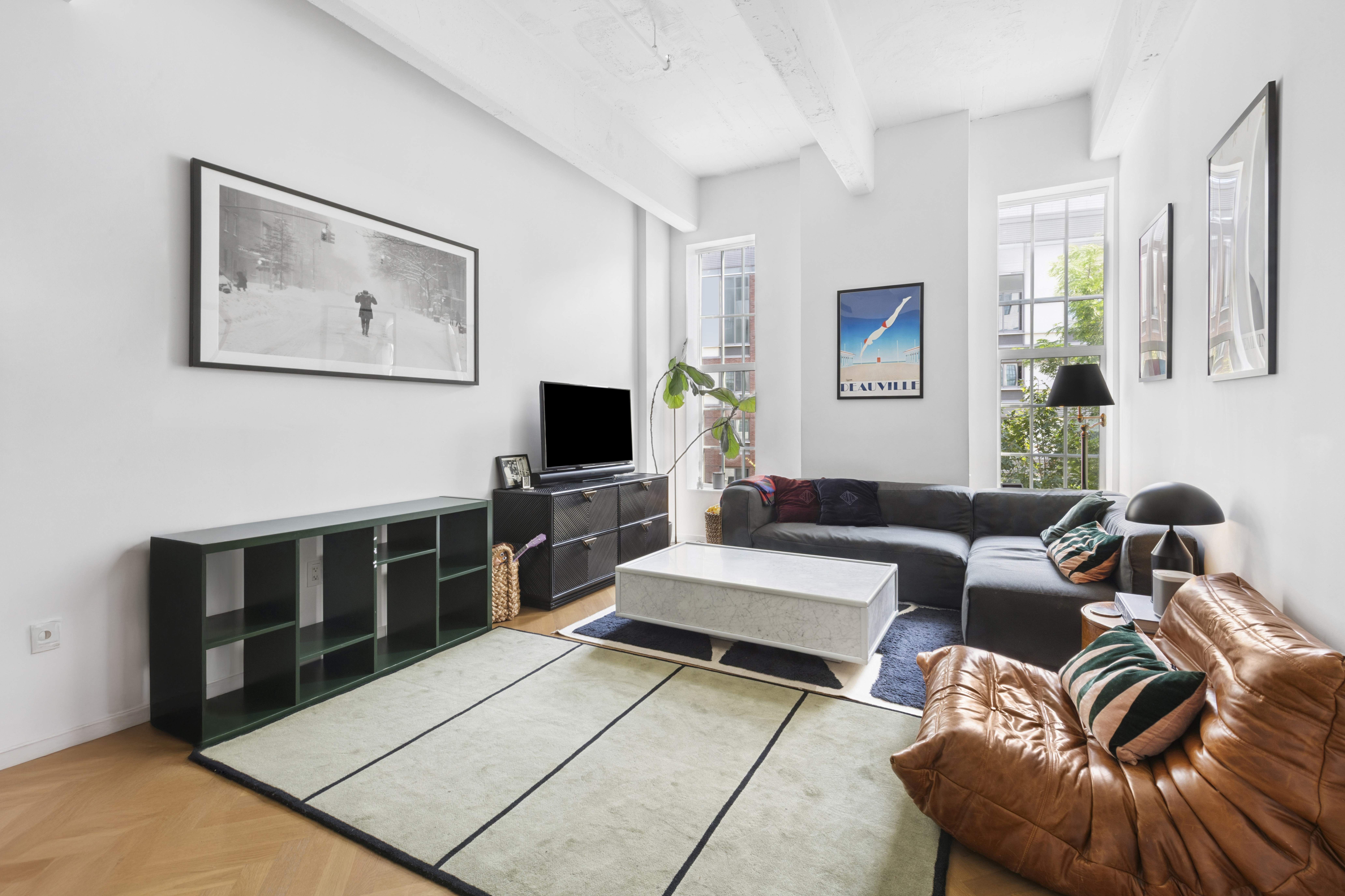 184 Kent Avenue, Unit D315 Brooklyn, NY 11249 - Photo 1 of 19 a living room with furniture a flat screen tv and kitchen view