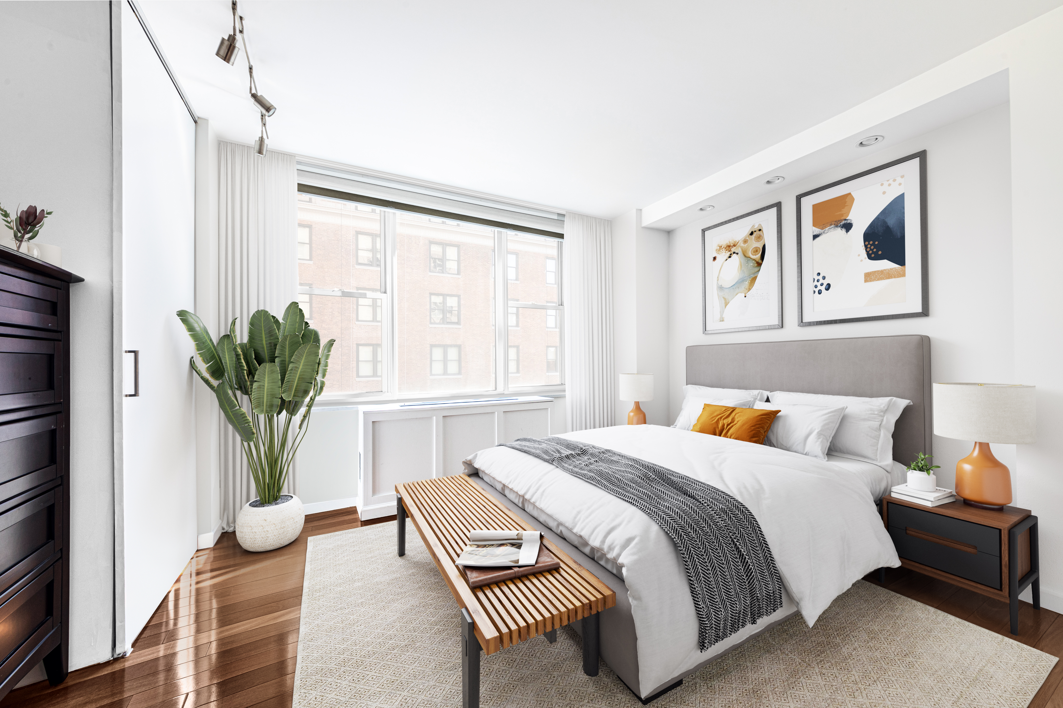 137 East 36th Street, Unit 8H Manhattan, NY 10016 - Photo 2 of 13 a bedroom with a bed and a couch