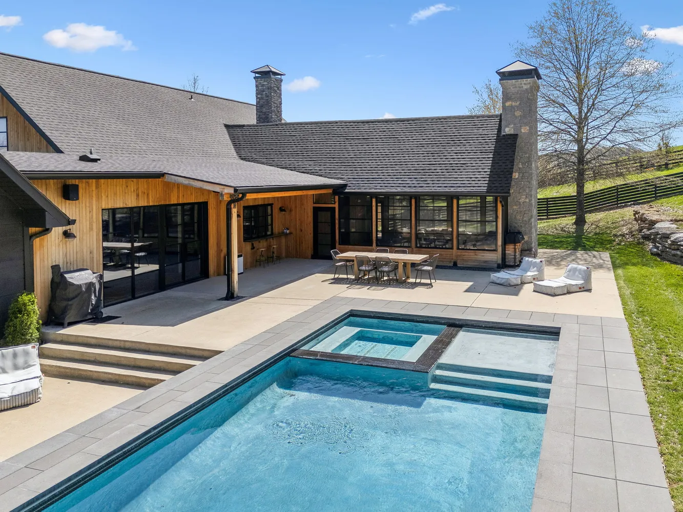 a outdoor patio with table and chairs