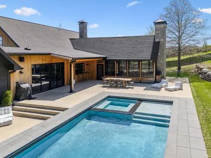 a outdoor patio with table and chairs
