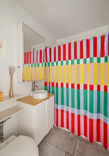 a bathroom with a sink and a curtain