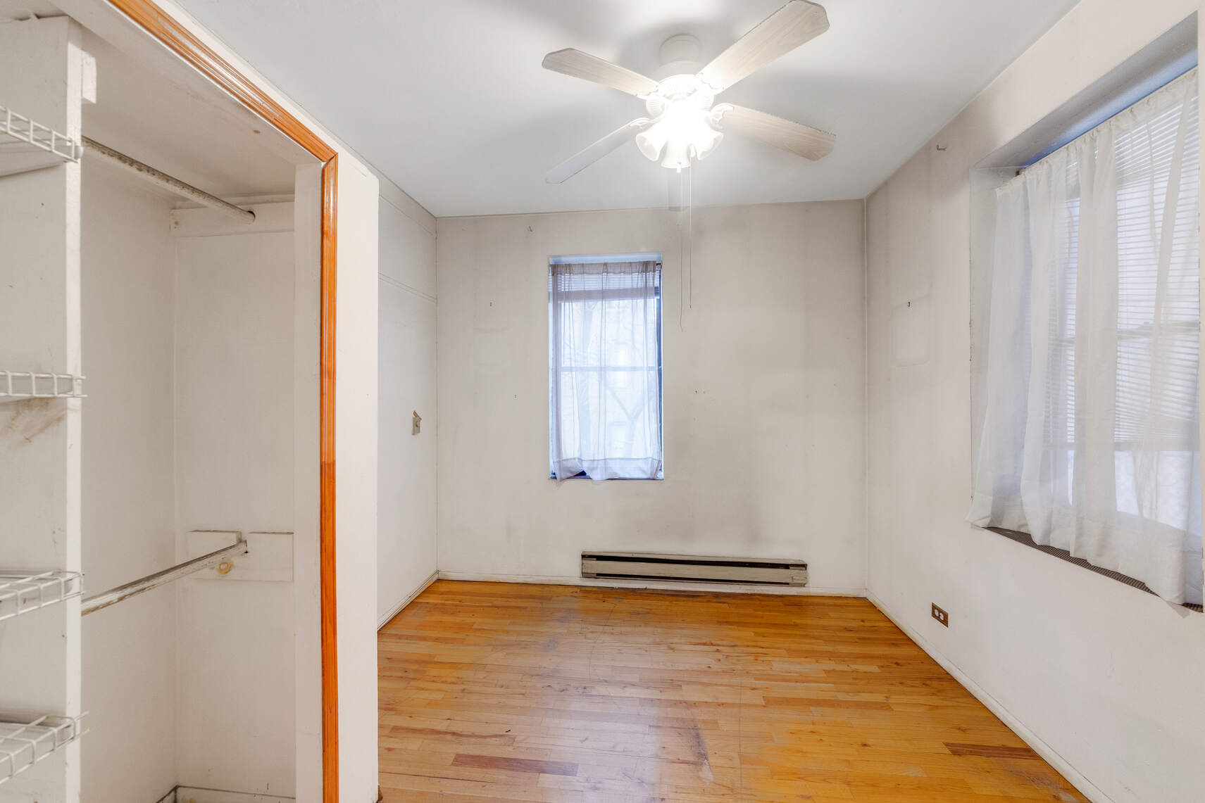 604 Riverside Drive, Unit 1B Manhattan, NY 10031 - Photo 9 of 14 a view of empty room with window and ceiling fan