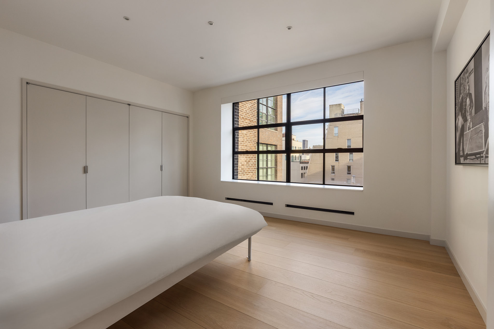 456 West 19th Street, Unit PHH Manhattan, NY 10011 - Photo 15 of 21 a bedroom with a bed and a window