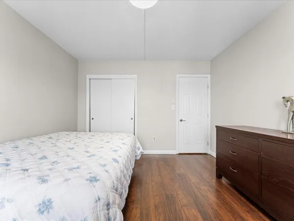 a bedroom with a bed and a dresser