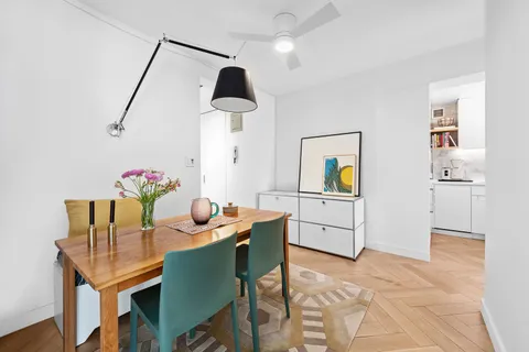 a dining room with furniture and window