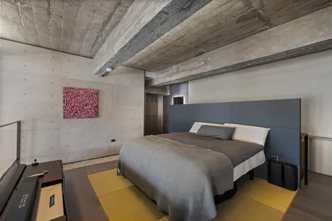 a bed sitting in a bedroom next to a window