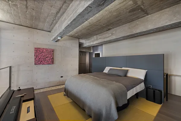 a bed sitting in a bedroom next to a window