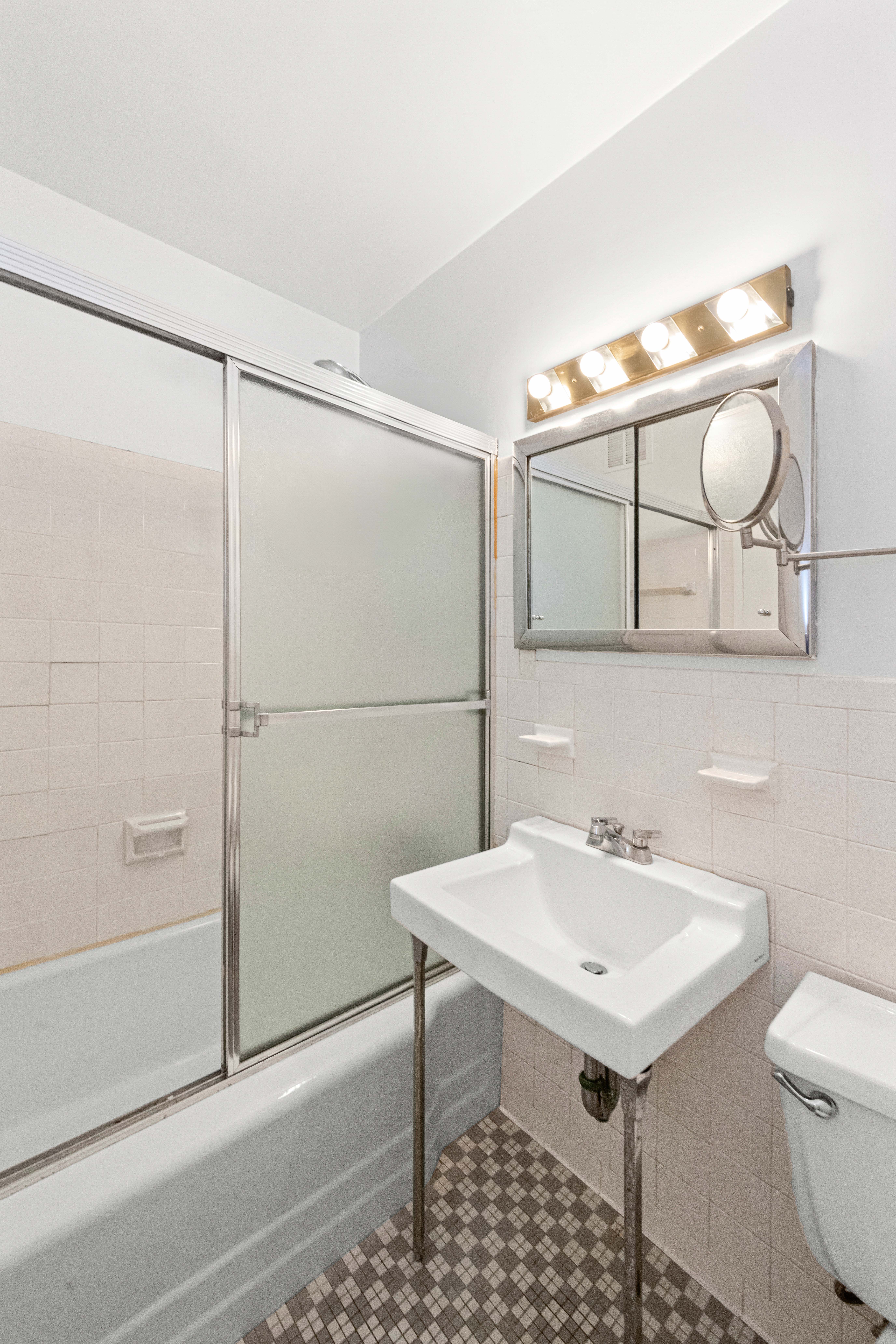 363 East 76th Street, Unit 6E Manhattan, NY 10021 - Photo 8 of 15 a bathroom with a sink and a mirror