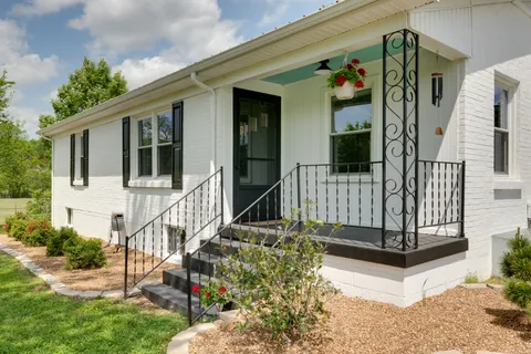 a view of a house with wooden fence