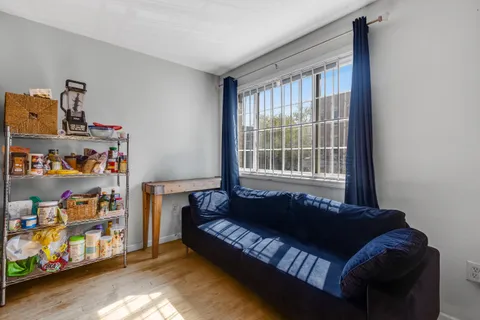 a bedroom with furniture and a window