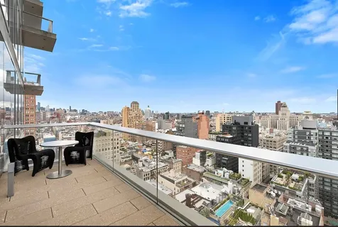 a terrace with outdoor seating and city view