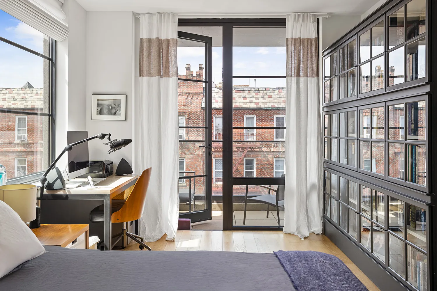 a view of a workspace with furniture and a window