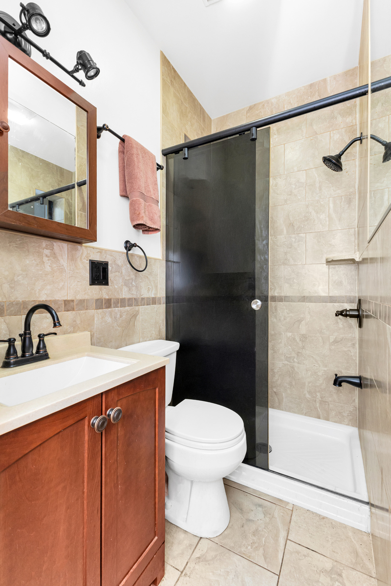 521 Dean Street, Unit 9 Brooklyn, NY 11217 - Photo 7 of 12 a bathroom with a sink toilet and shower