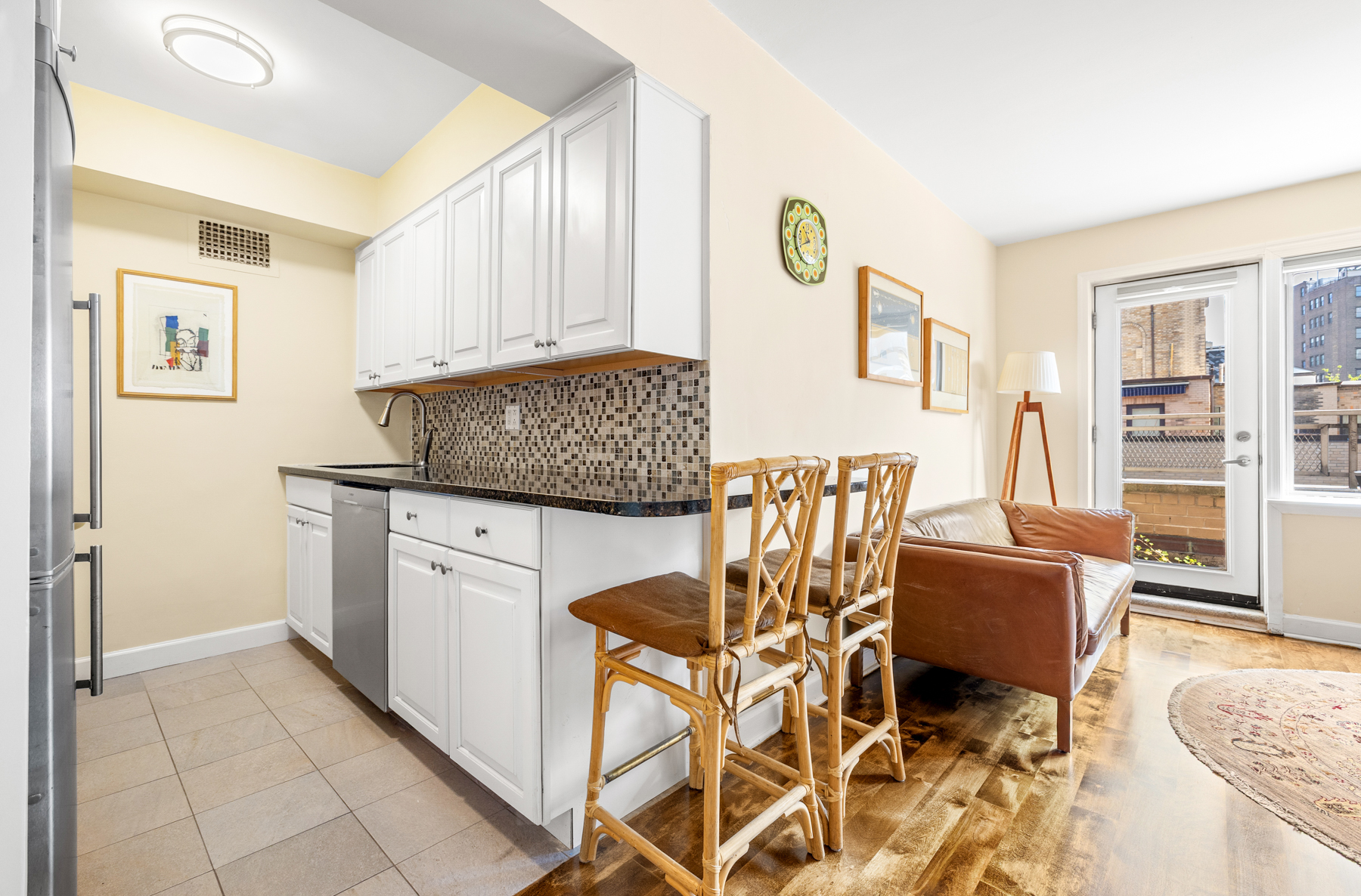 55 East 9th Street, Unit 12H Manhattan, NY 10003 - Photo 3 of 9 a living room with a dining table and chairs