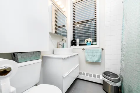 a bathroom with a sink a mirror and toilet