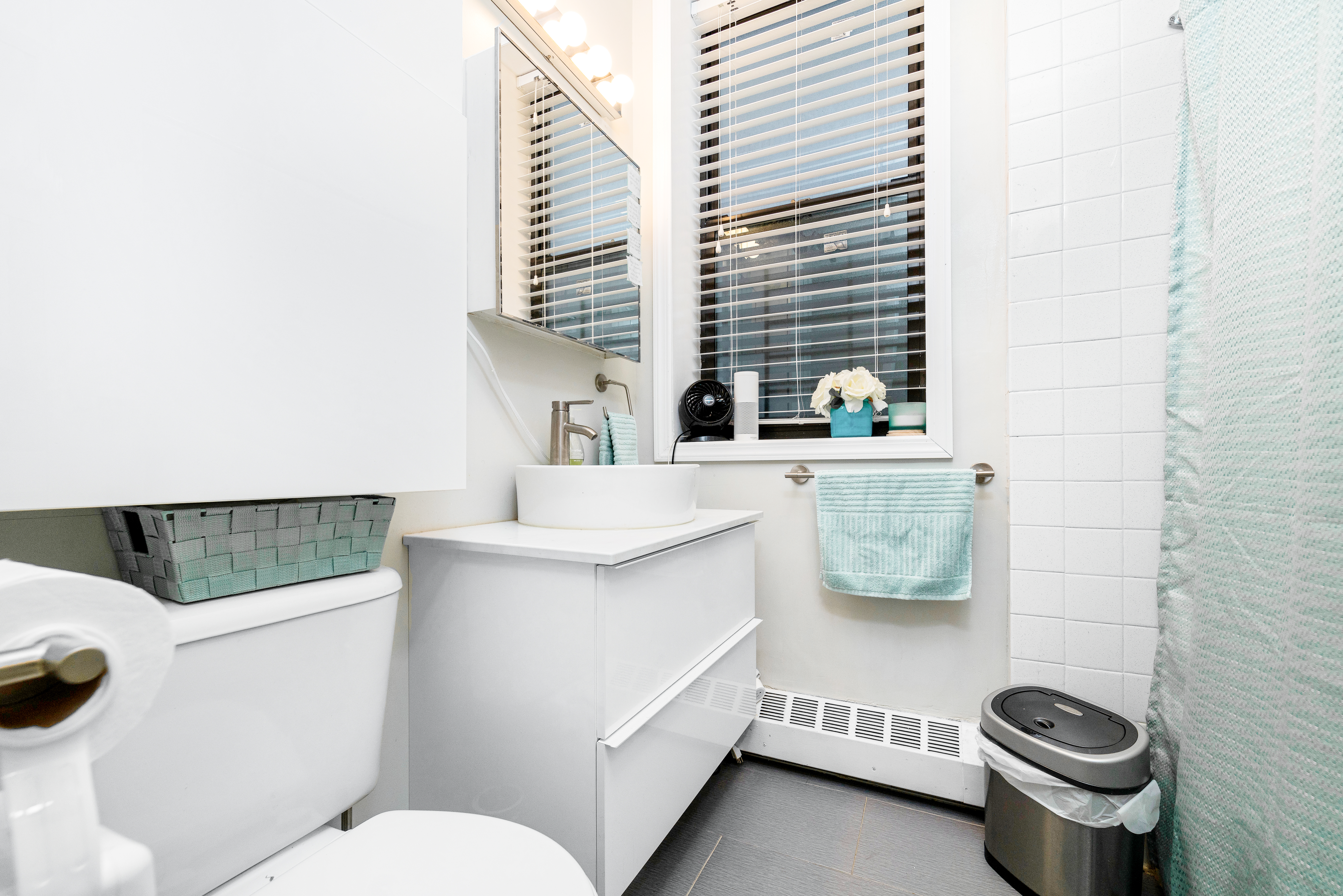 108 West 114th Street, Unit 4B Manhattan, NY 10026 - Photo 8 of 9 a bathroom with a sink a mirror and toilet