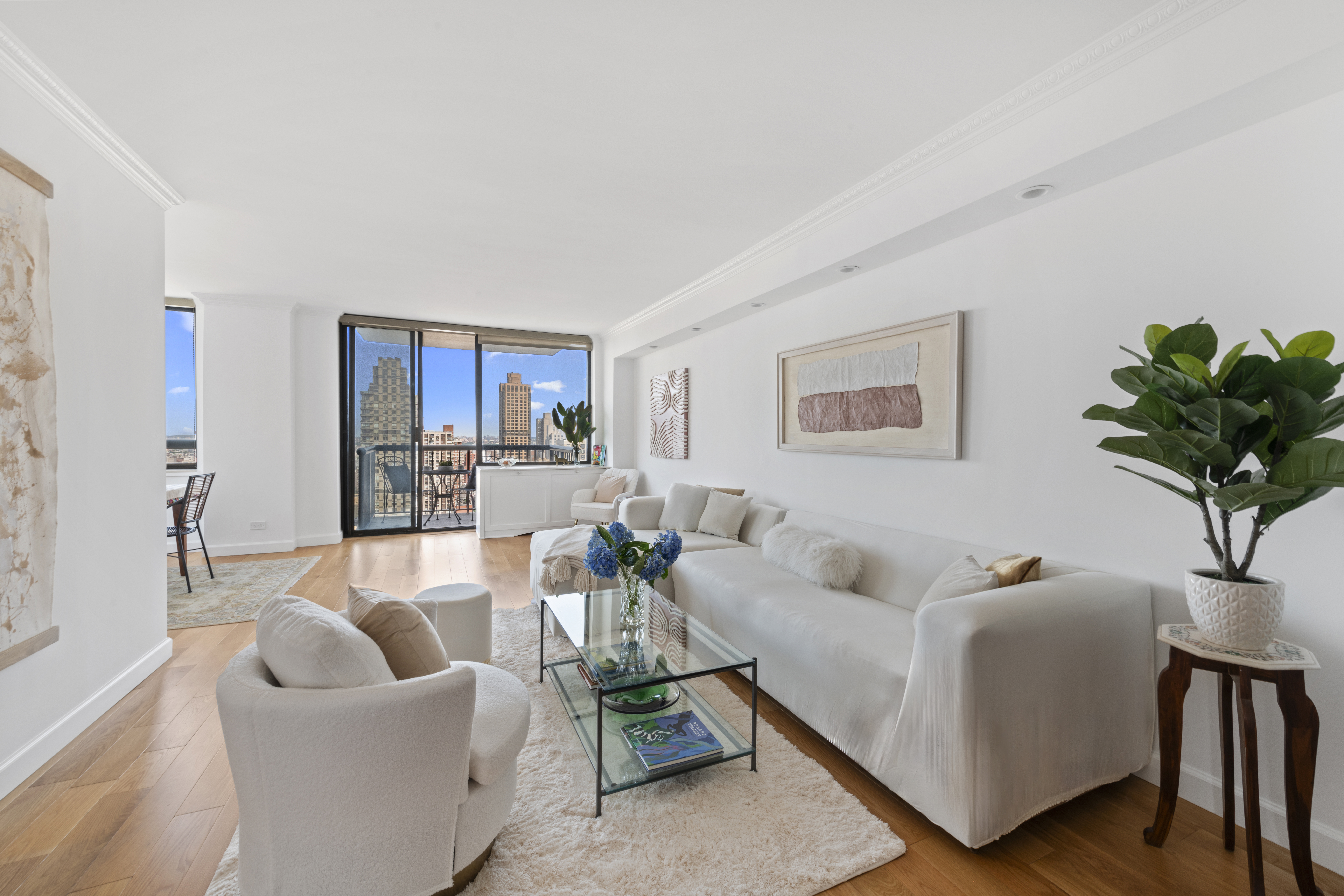 171 East 84th Street, Unit 31C Manhattan, NY 10028 - Photo 2 of 18 a living room with furniture and a potted plant