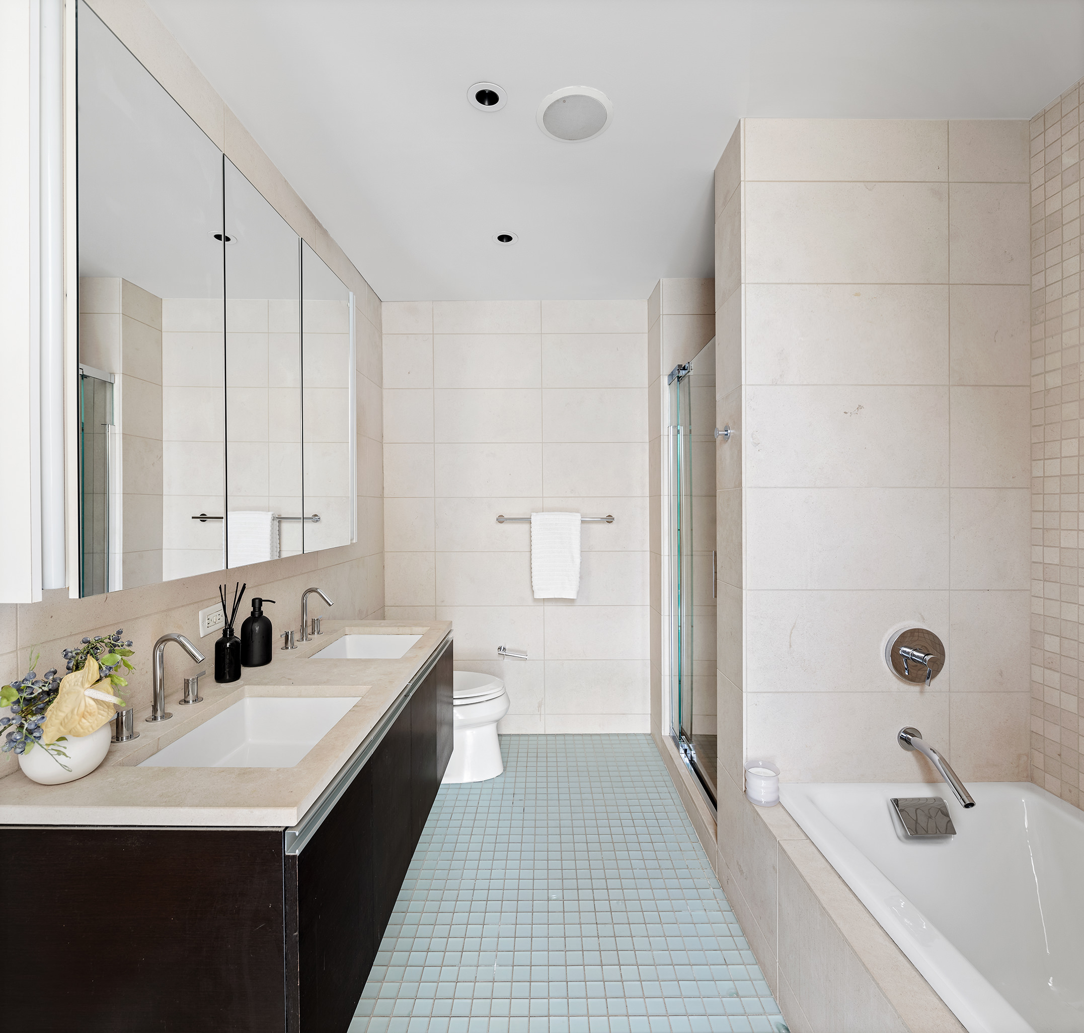 110 3rd Avenue, Unit 4B Manhattan, NY 10003 - Photo 7 of 15 a bathroom with a double vanity sink a mirror and a bathtub