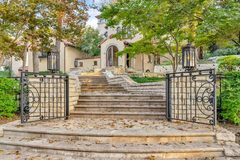 a front view of a house with a garden