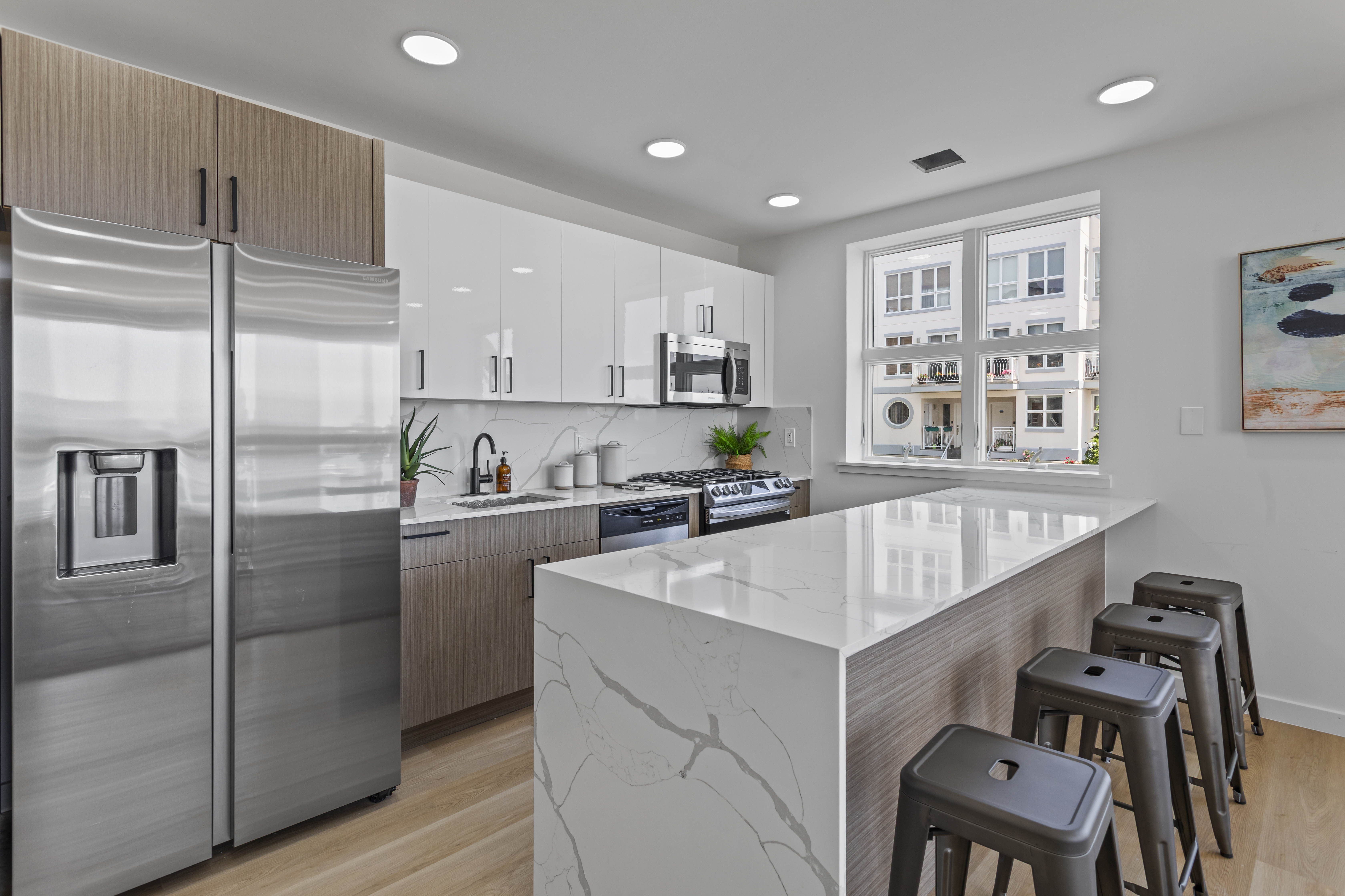 3112 Emmons Avenue, Unit 3124A2 Brooklyn, NY 11235 - Photo 3 of 17 a kitchen with kitchen island a counter top space cabinets and stainless steel appliances