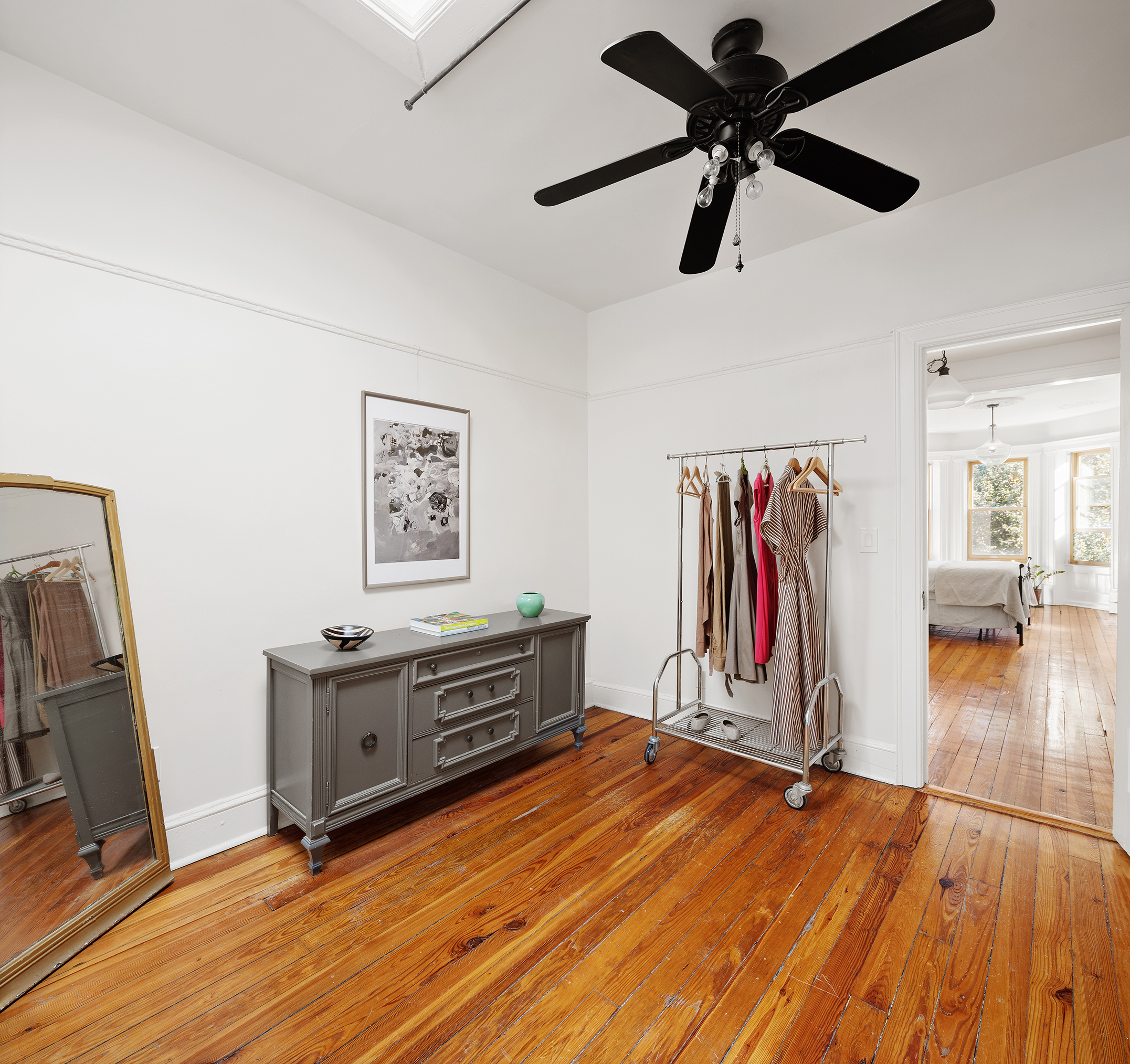 195 Lefferts Avenue Brooklyn, NY 11225 - Photo 10 of 18 a view of a livingroom with hardwood floor and a ceiling fan
