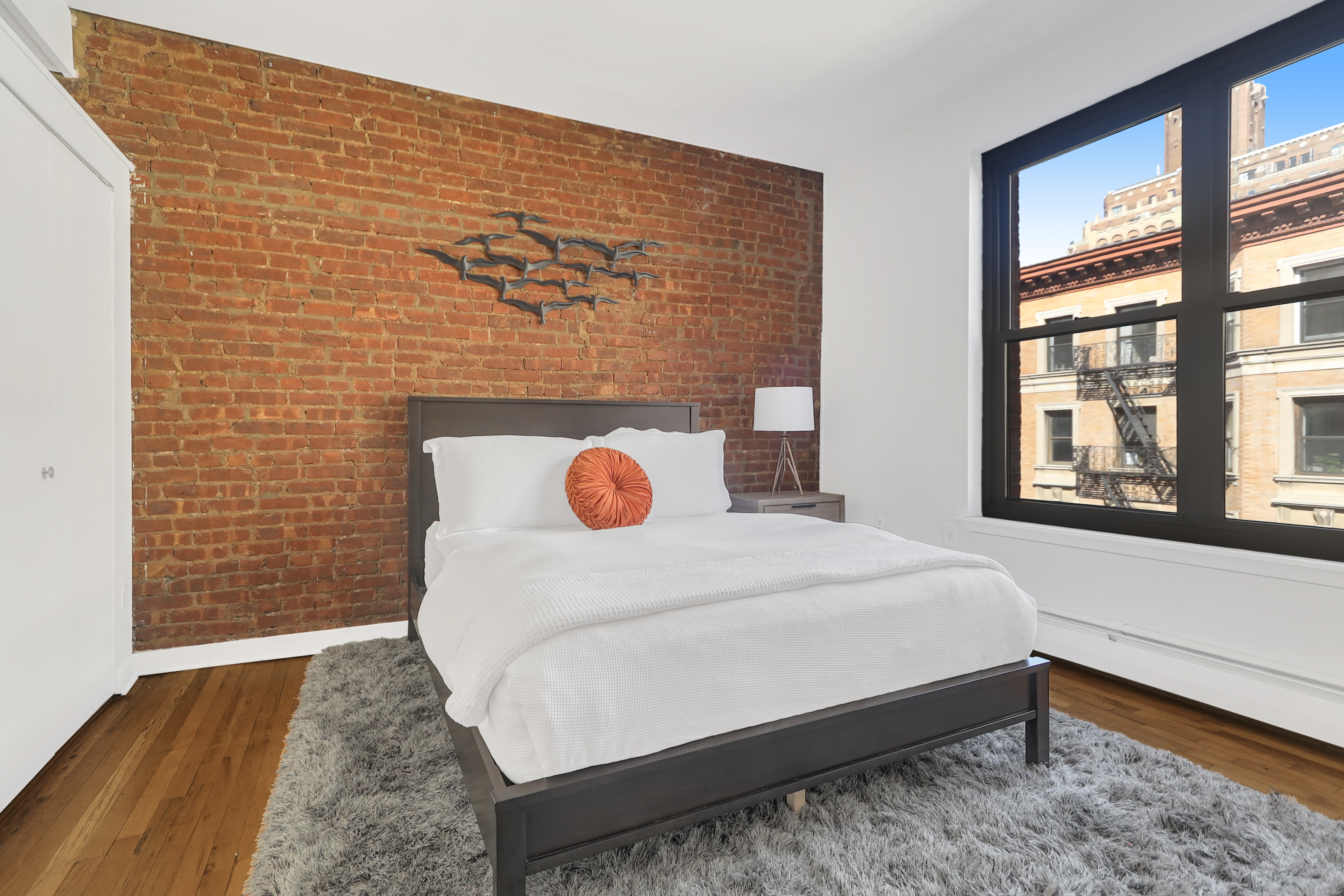 314 West 94th Street, Unit 5D Manhattan, NY 10025 - Photo 8 of 13 a bed sitting in a bedroom next to a window