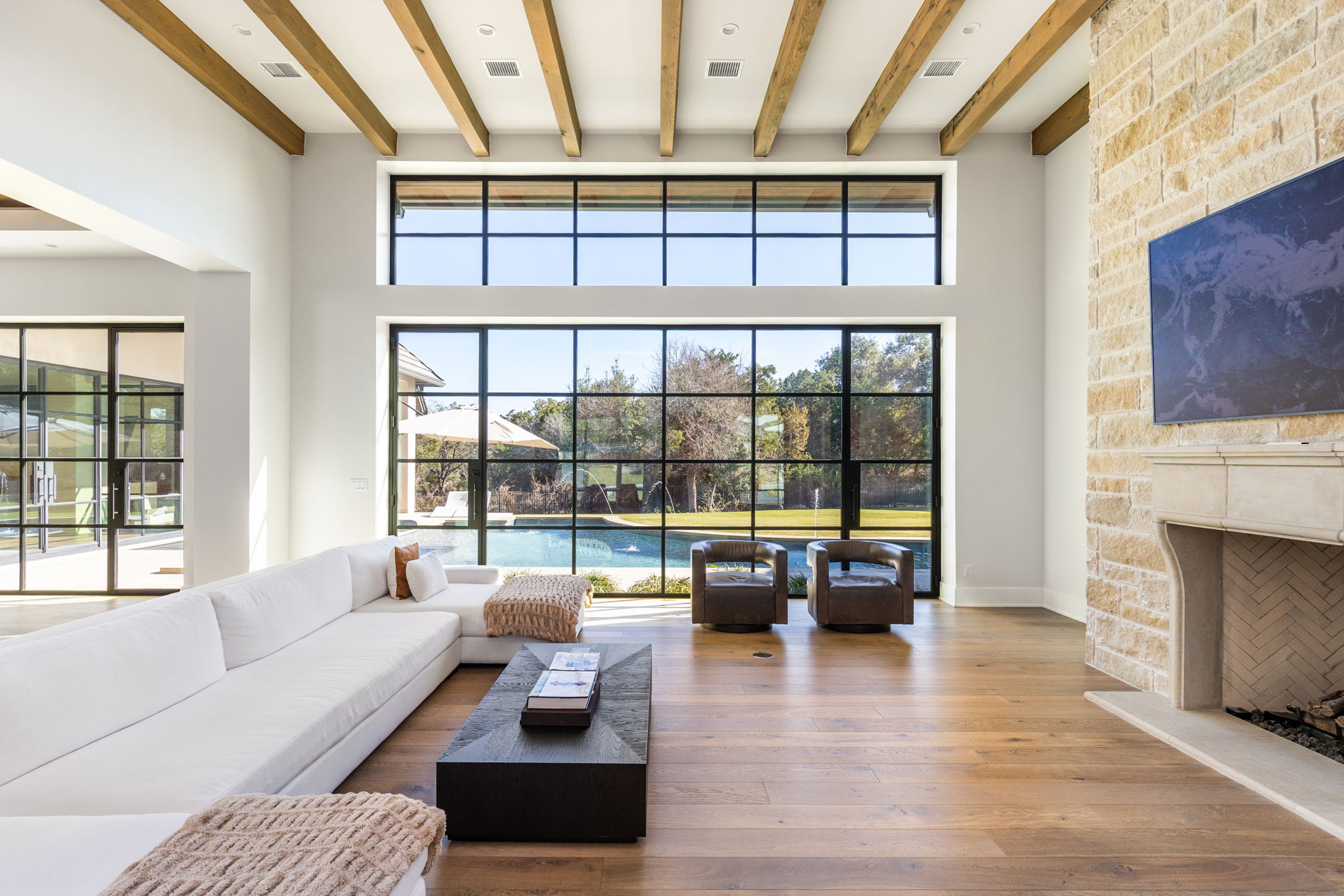 522 Delayne Drive Austin, TX 78737 - Photo 15 of 23 a living room with furniture large fireplace and floor to ceiling windows