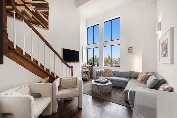 a living room with furniture or stairs and a wooden floor