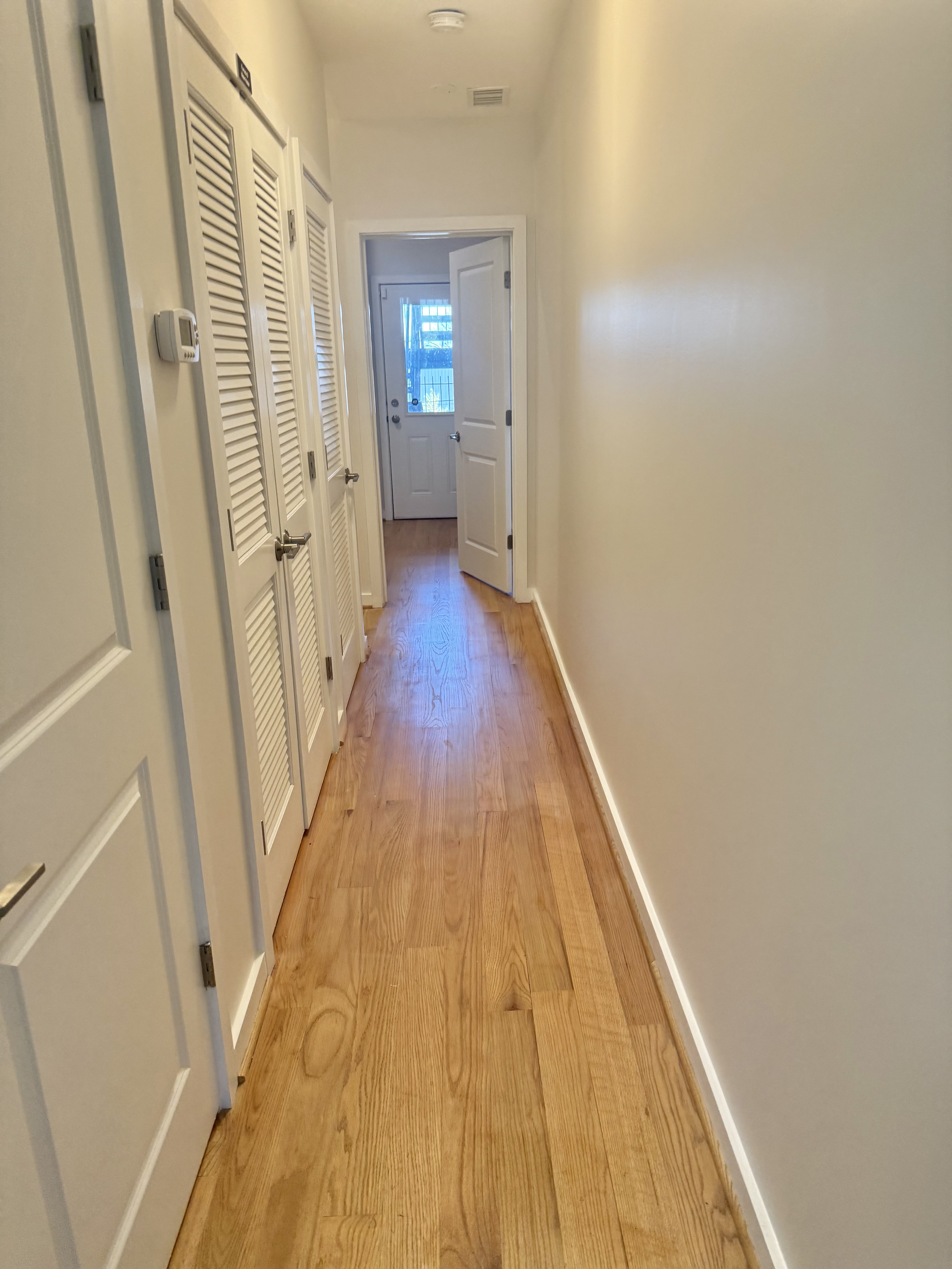 2009 Benning Road Northeast, Unit 2 Washington, DC 20002 - Photo 5 of 11 a view of a hallway with wooden floor and staircase