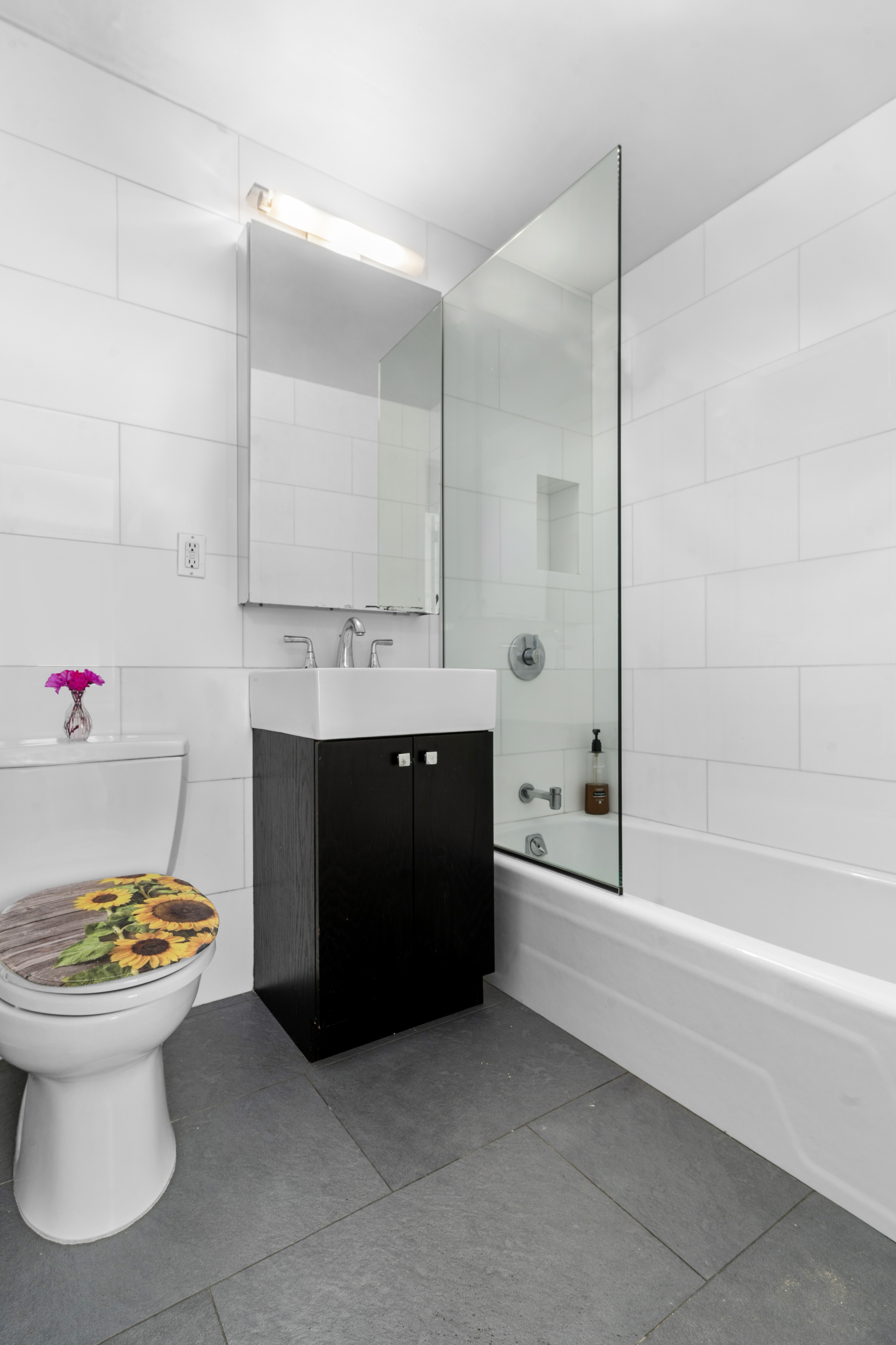 201 West 70th Street, Unit 7H Manhattan, NY 10023 - Photo 8 of 15 a bathroom with a sink and a mirror