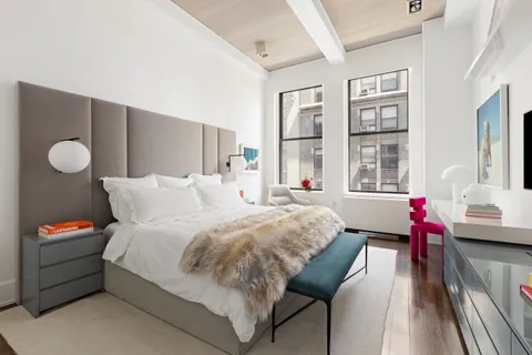 a bedroom with bed and a large window