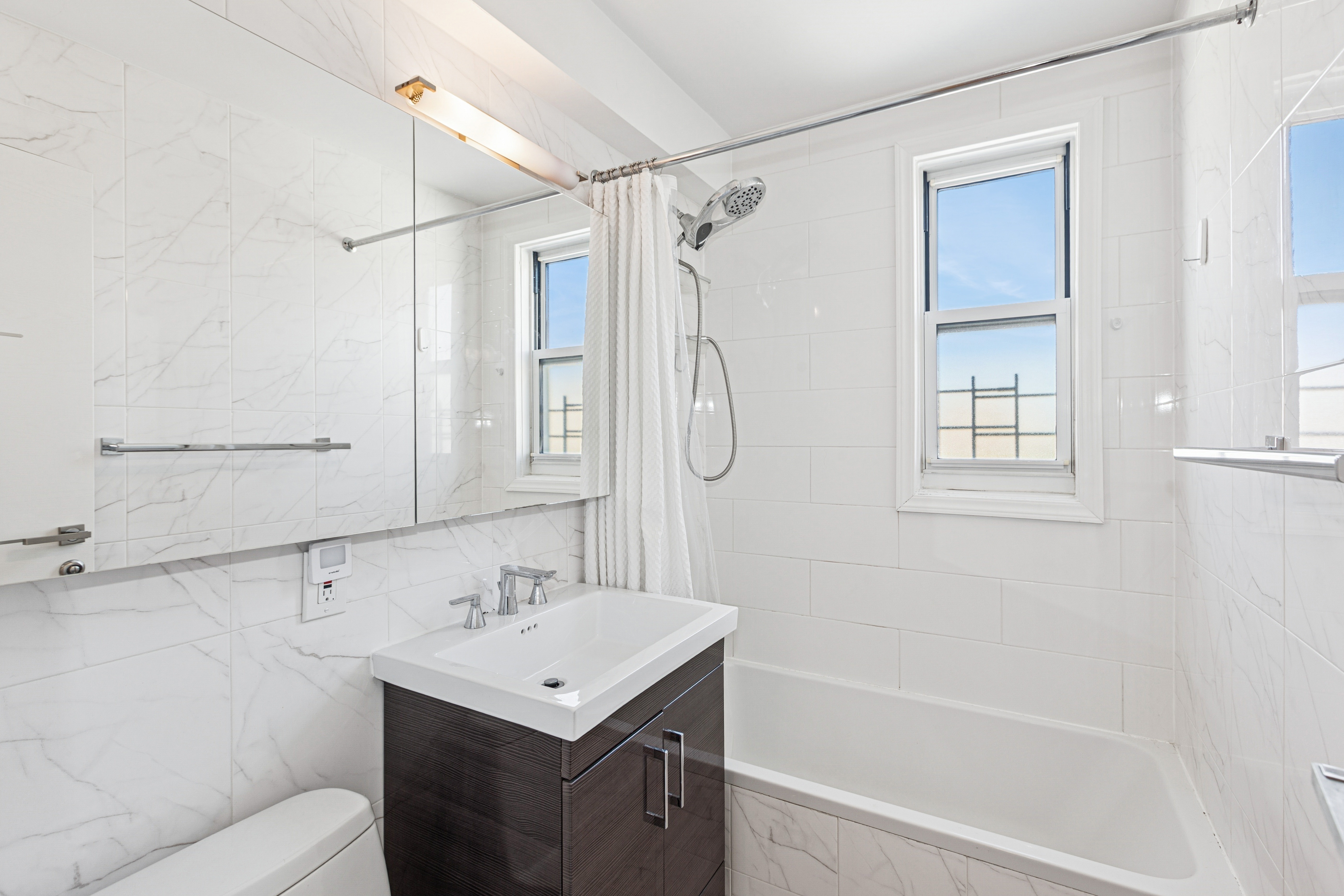 1270 5th Avenue, Unit 12C Manhattan, NY 10029 - Photo 11 of 18 a bathroom with a sink toilet tub and shower